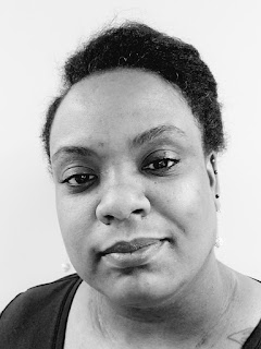 A black woman in a black shirt.